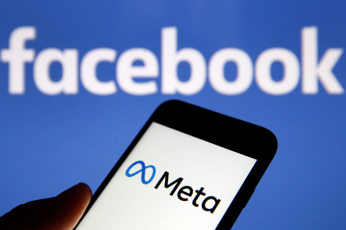 In this photo illustration, the Meta logo is displayed on the screen of an iPhone in front of a Facebook logo on 29 October 2021 [Chesnot/Getty Images]