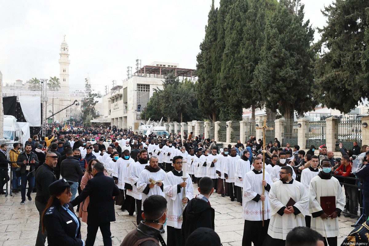 Palestinian Christians seen during the mass held at Church of the Nativity, in Bethlehem, West Bank on December 24, 2021 [Issam Rimawi / Anadolu Agency]