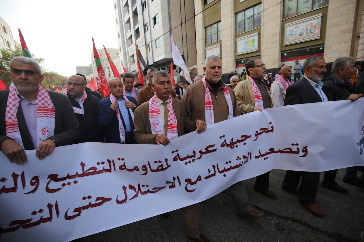 The Popular Front for the Liberation of Palestine commemorates its 54th anniversary in front of the Red Cross headquarters in Gaza, in solidarity with Palestinian prisoners held in Israeli jails on 13 December 2021 [Mohammed Asad/Middle East Monitor]