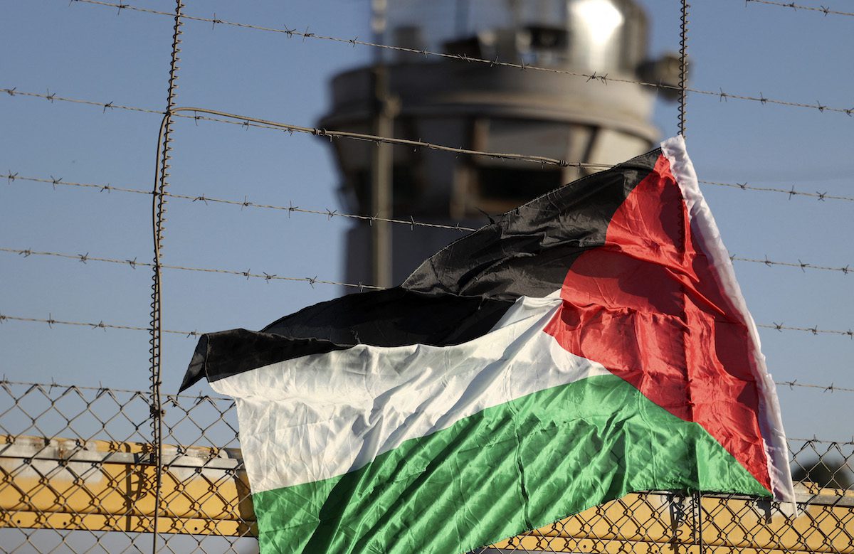A Palestinian flag is pictured on the fence of Israel's Ofer prison near the city of Ramallah in the occupied West Bank, on July 12, 2021 [ABBAS MOMANI/AFP via Getty Images]
