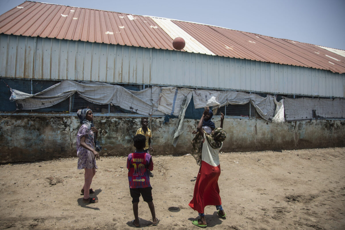 Children play with a ball in refugee camp on August 15, 2021 [Abdulmonam Eassa/Getty Images]