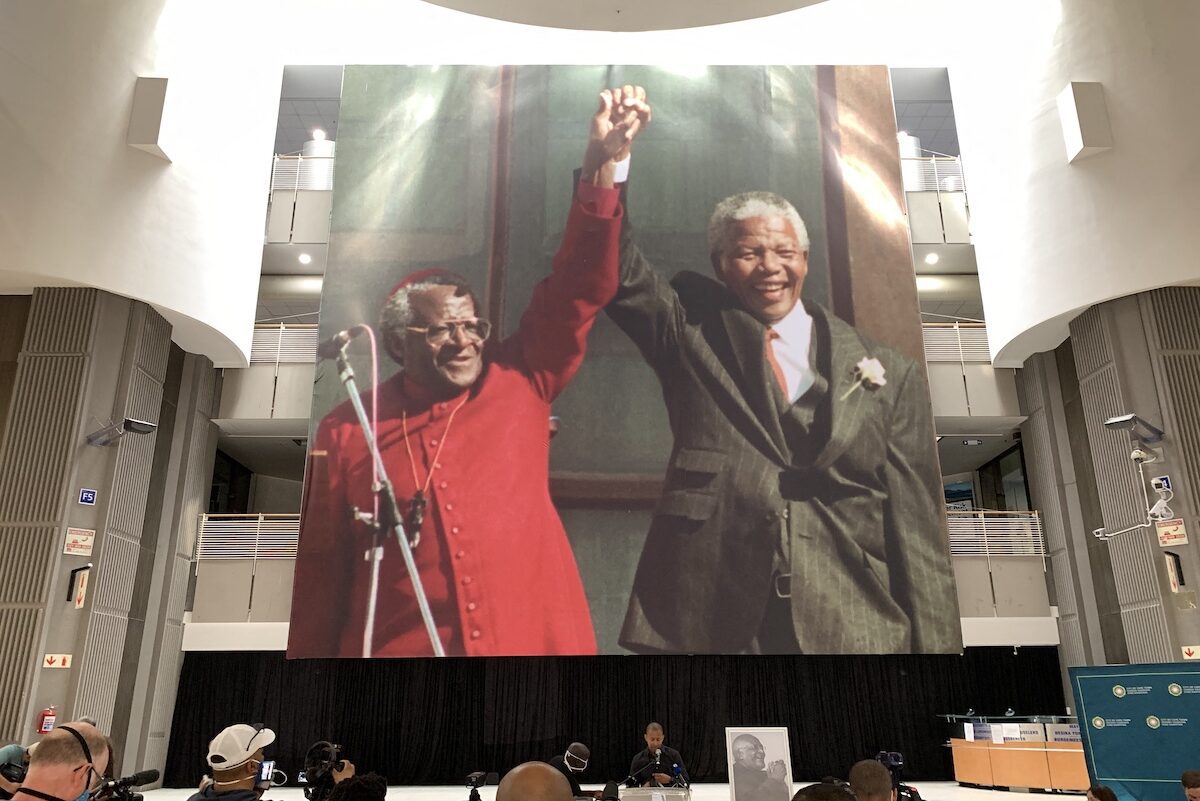 Members of the media attend a press bfriefing at the Cape Town Civic Centre in Cape Town on 26 December 2021 after the news of the passing of South African anti-apartheid icon Desmond Tutu. [GIANLUIGI GUERCIA/AFP via Getty Images]