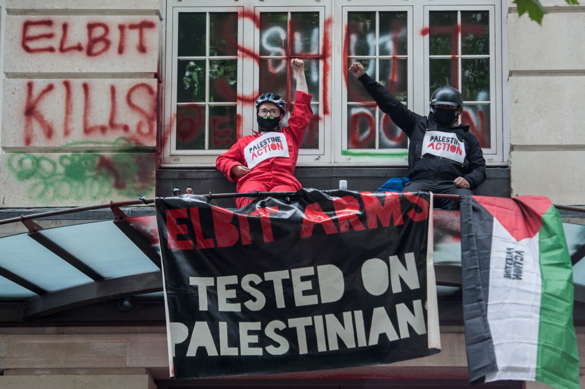 Palestine Action activists occupy the balcony at the offices of Israeli arms company Elbit Systems on August 6, 2021 in London, England [Guy Smallman/Getty Images]