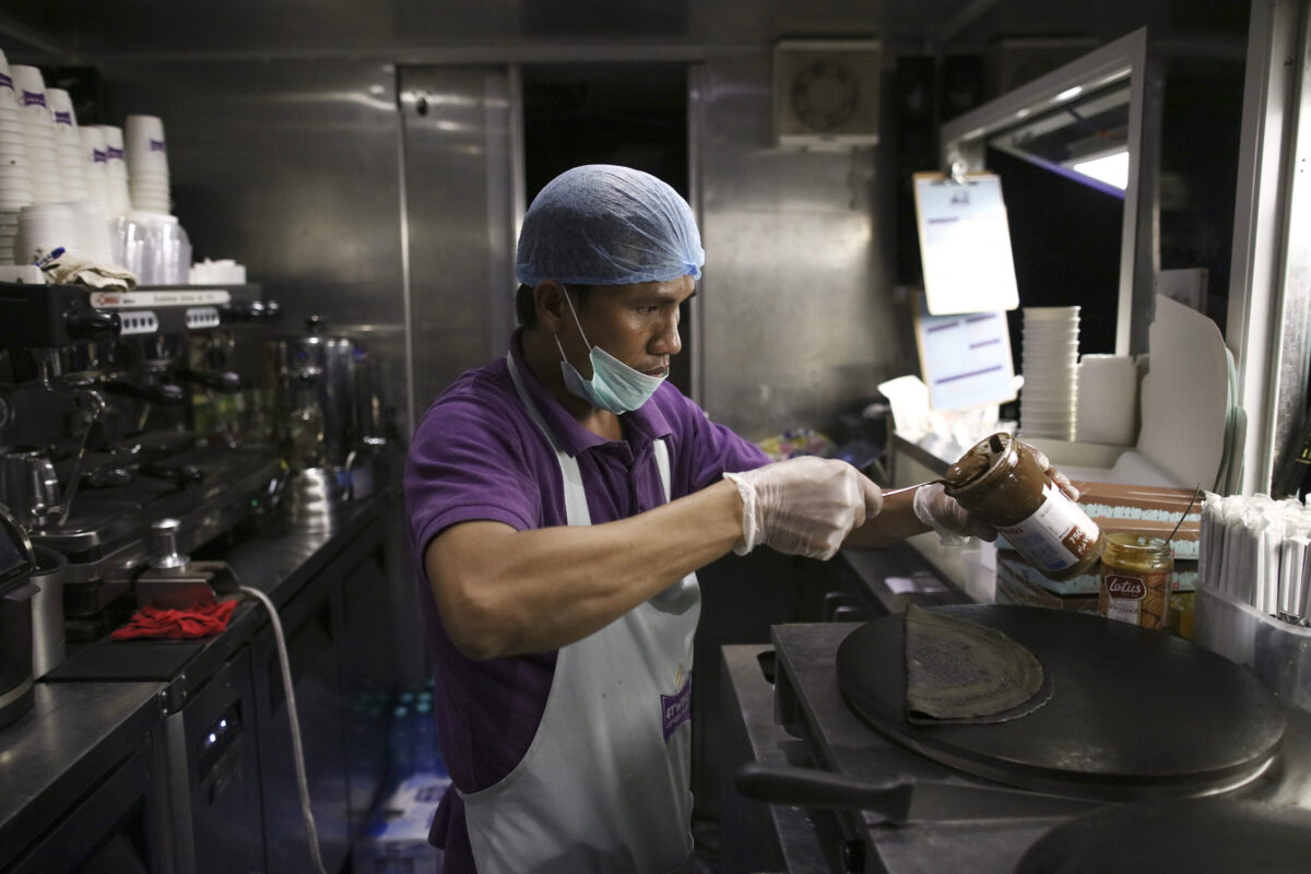 A cook from the Philippines prepares a 'black crepe' for a customer from a mobile food van located on the side of a highway in Riyadh, Saudi Arabia, on Tuesday, Nov. 29, 2016. Saudi Arabia is working to reduce the the Middle Easts biggest economys reliance on oil, which provides three-quarters of government revenue, as part of a plan for the biggest economic shakeup since the countrys founding. Photographer: Simon Dawson/Bloomberg via Getty Images