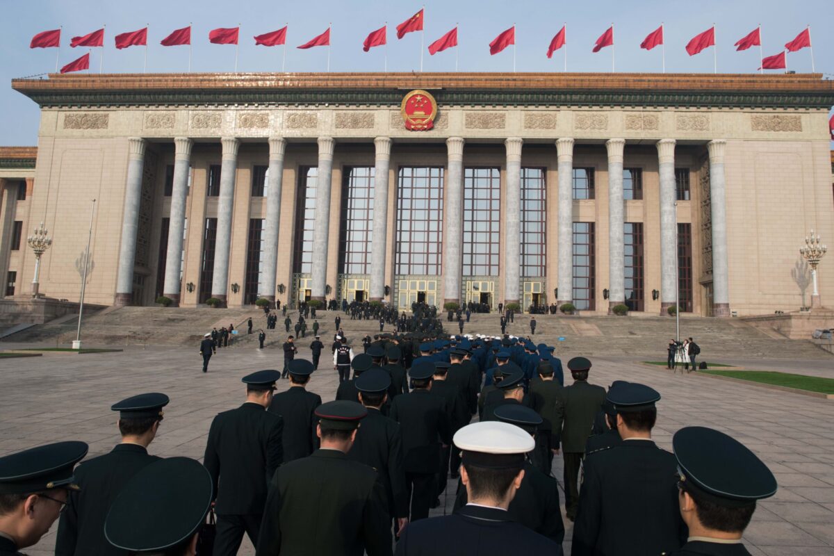 Military delegates arrive for the 7th plenary session of the National People's Congress (NPC) at the Great Hall of the People in Beijing on March 19, 2018. / AFP PHOTO / NICOLAS ASFOURI (Photo credit should read NICOLAS ASFOURI/AFP via Getty Images)