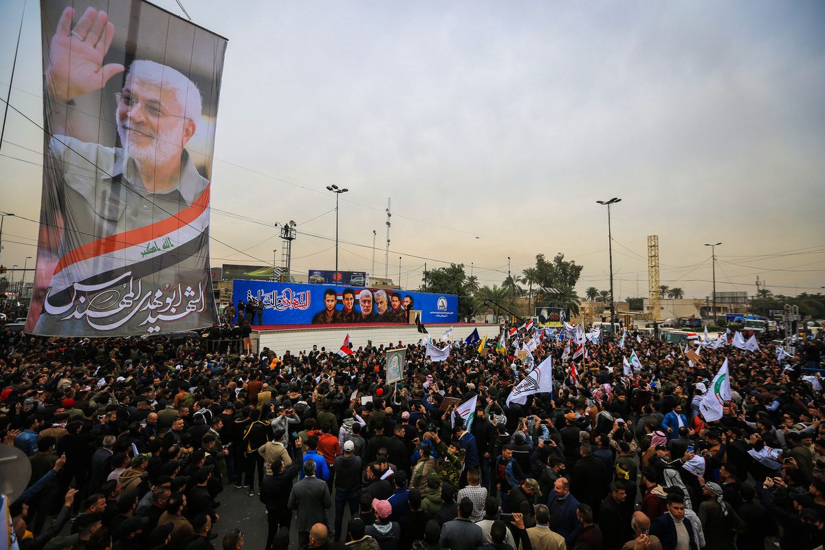 People gather near Baghdad International Airport to commemorate the second anniversaries of the killing of Iranian Revolutionary Guards' Quds Force commander Qasem Soleimani and the vice president of the Hashd al-Shaabi group Abu Mahdi al-Muhandis, on January 01, 2022 in Bahgdad, Iraq [Murtadha Al-Sudani - Anadolu Agency]