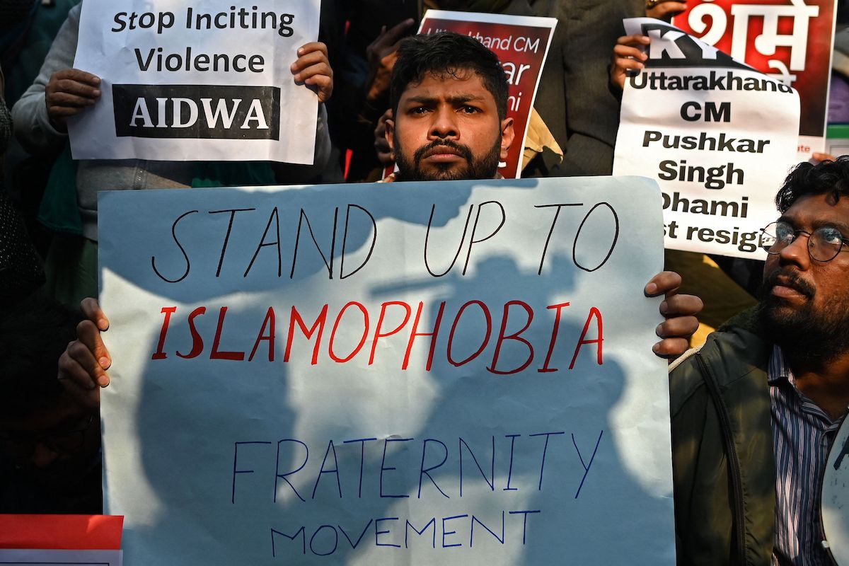 Protesters from various organisations take part in a demonstration in New Delhi on December 27, 2021, after the Indian police on December 24 said they have launched an investigation into an event where Hindu hardliners called for mass killings of minority Muslims. [SAJJAD HUSSAIN/AFP via Getty Images]