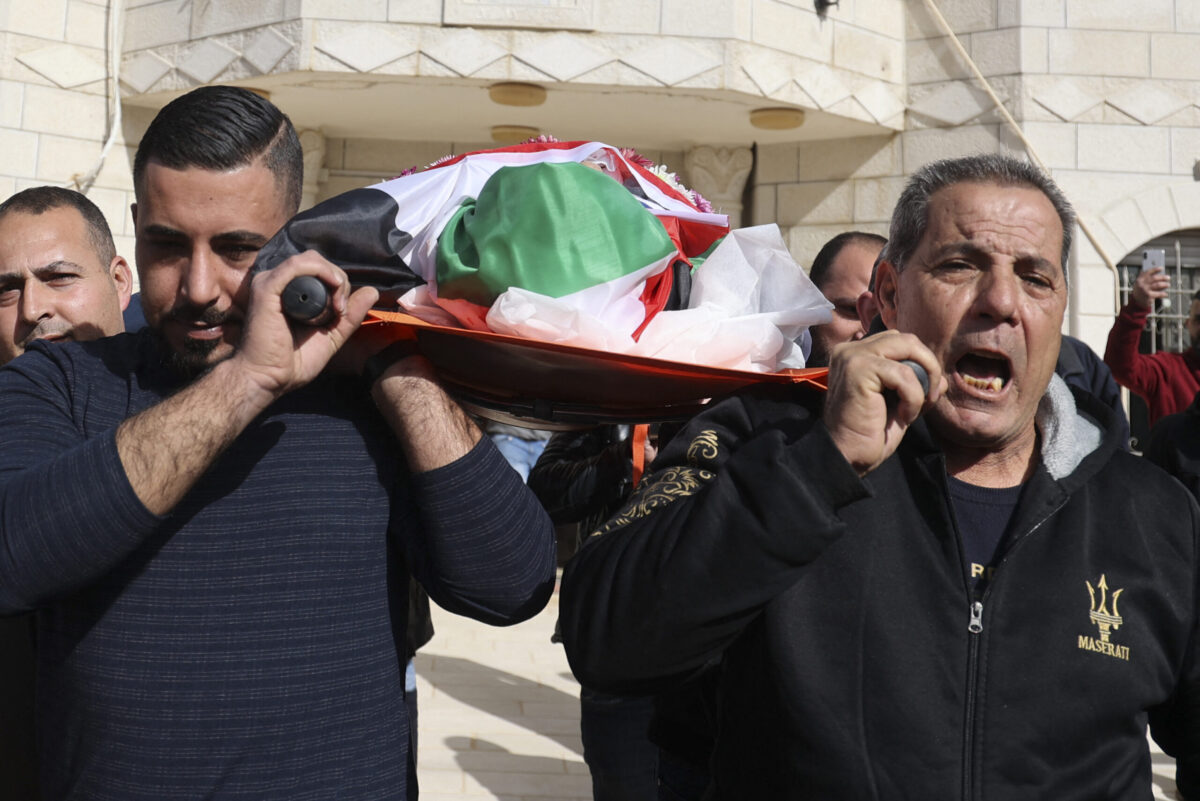Palestinian relatives mourn during the funeral of Omar Abdalmajeed As'ad, 80, who was found dead after being detained and handcuffed during an Israeli raid, in Jiljilya village in the Israeli-occupied West Bank, on January 13, 2022 [JAAFAR ASHTIYEH/AFP via Getty Images]
