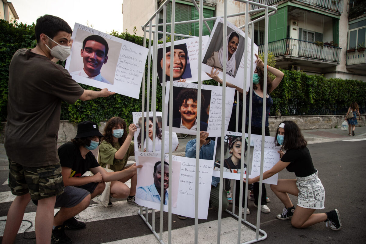 A photo of Patrick Zaki and those of other human rights activists detained around the world exhibited in a cell during a demonstration for freedom of expression on June 16, 2021 in Naples, Italy [Ivan Romano/Getty Images]