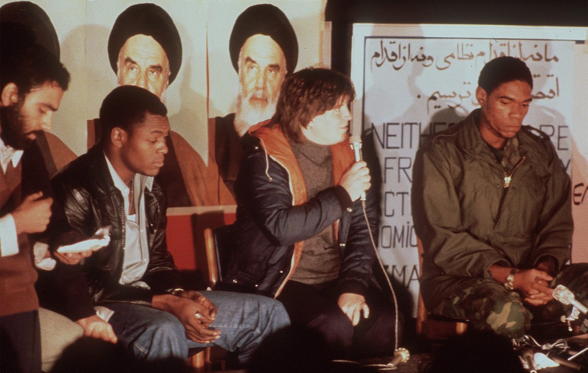 The first released group of US Embassy staffers in Tehran hold a press conference 18 November 1979, the day after Ayatollah Khomeini ordered the release of all women and black U.S. hostages. [H. KOTILAINEN/AFP via Getty Images]