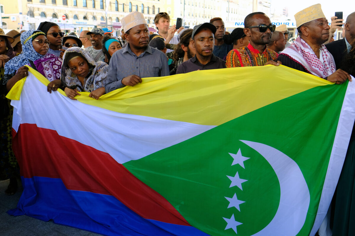 Activists from the Comoros wave flags on June 10, 2017 [BORIS HORVAT/AFP via Getty Images]