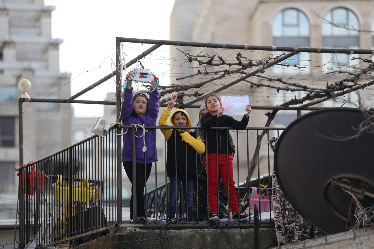 Children are seen as activists gather for a demonstration to protest against the eviction of Palestinian families from their homes and illegal settlements in Sheikh Jarrah neighborhood, East Jerusalem on 11 February 2022. [Mostafa Alkharouf - Anadolu Agency]