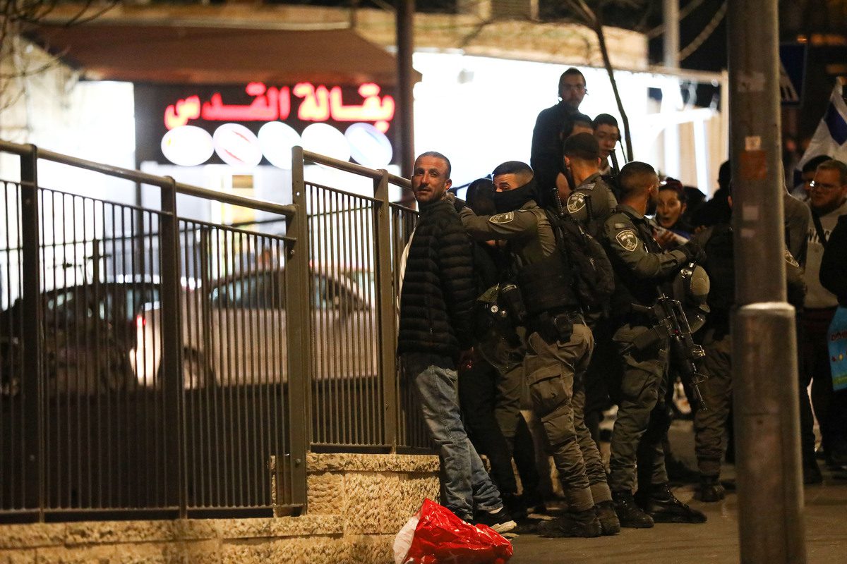 Israeli forces arrest a Palestinian man in Sheikh Jarrah, Jerusalem on 13 February 2022 [Mostafa Alkharouf/Anadolu Agency]