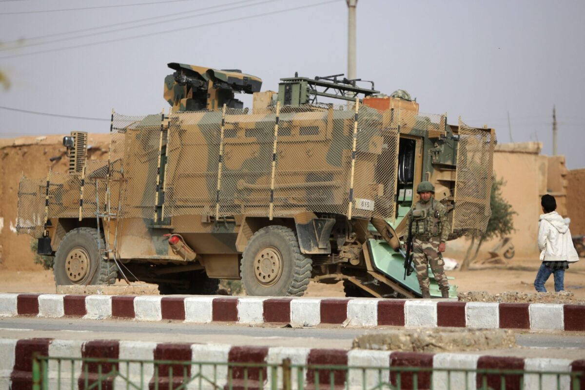 A Turkish soldier stands near his armoured vehicl on November 26, 2019 [BAKR ALKASEM/AFP via Getty Images]