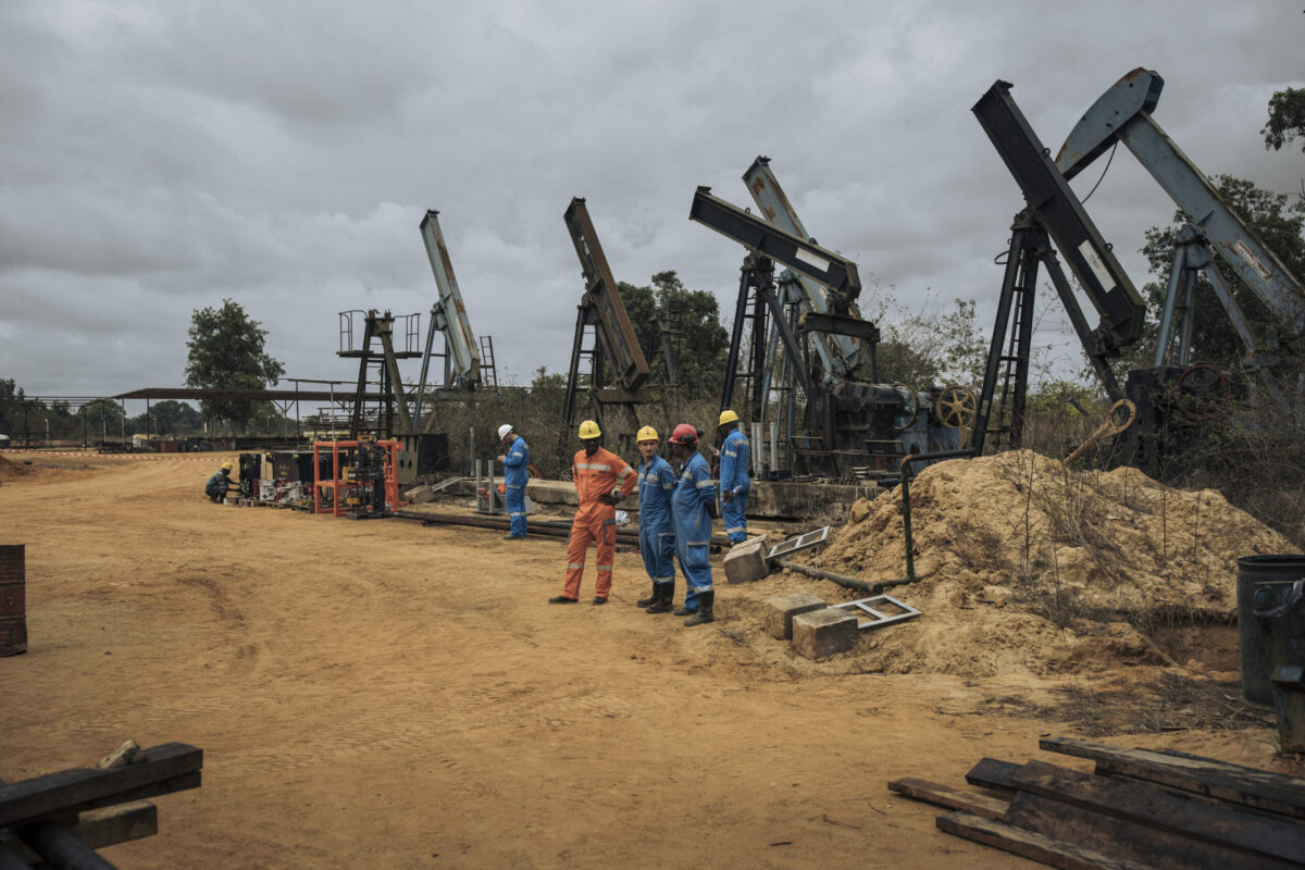 Perenco oil company managers and technicians watch one of the onshore oil wells in operation on the outskirts of Muanda, on the southwestern tip of the Democratic Republic of Congo on October 19, 2021 [ALEXIS HUGUET/AFP via Getty Images]