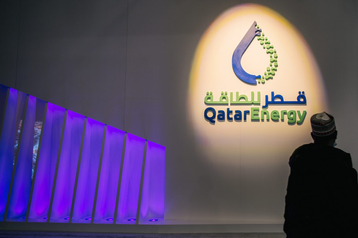 A person stands near the Qatar Energy section at an exhibition during the 23rd World Petroleum Congress conference at the George R. Brown Convention Center on 7 December 2021 in Houston, Texas. [Brandon Bell/Getty Images]