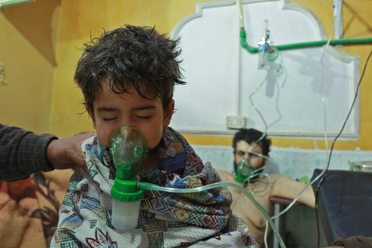 Syrian children and adults receive treatment for a suspected chemical attack on the outskirts of the capital Damascus late on February 25, 2018 [HAMZA AL-AJWEH/AFP via Getty Images]