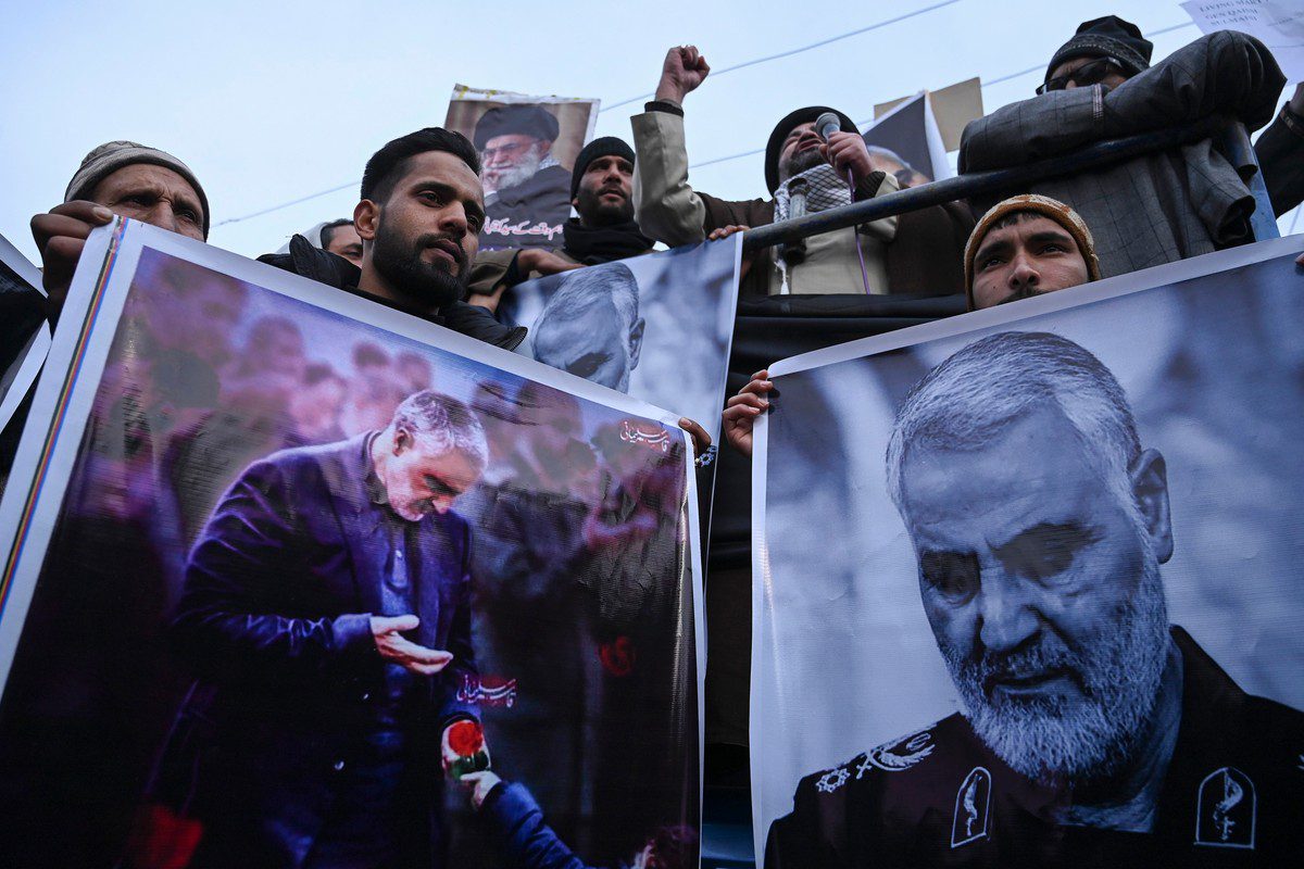 Protesters in Kashmir hold posters of Iranian commander Qassem Soleimani, who was killed by a US air strike in Iraq, 3 January 2020 [TAUSEEF MUSTAFA/AFP/Getty Images]