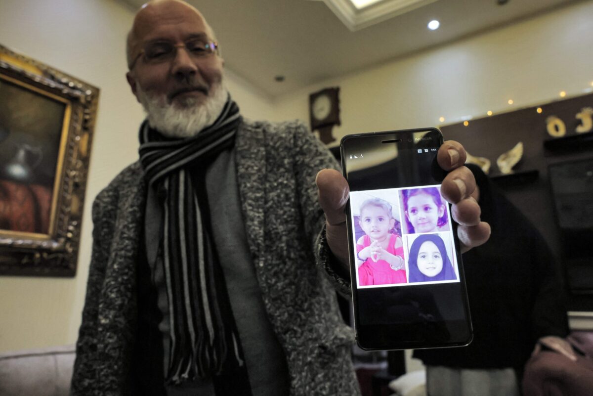 Khaled Androun, a Lebanese national whose daughter Alaa is a widow of a Daesh group fighter and is currently held at a high-security annex the northeast Syrian camp of al-Hol, shows a photo of his granddaughters on a phone on February 10, 2022 [JOSEPH EID/AFP via Getty Images]