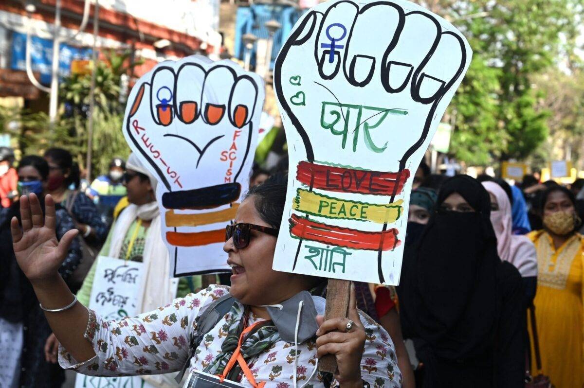 Social activists hold placards as they participate in rally to observe International Womans Day in Kolkata on March 8, 2022 [DIBYANGSHU SARKAR/AFP]