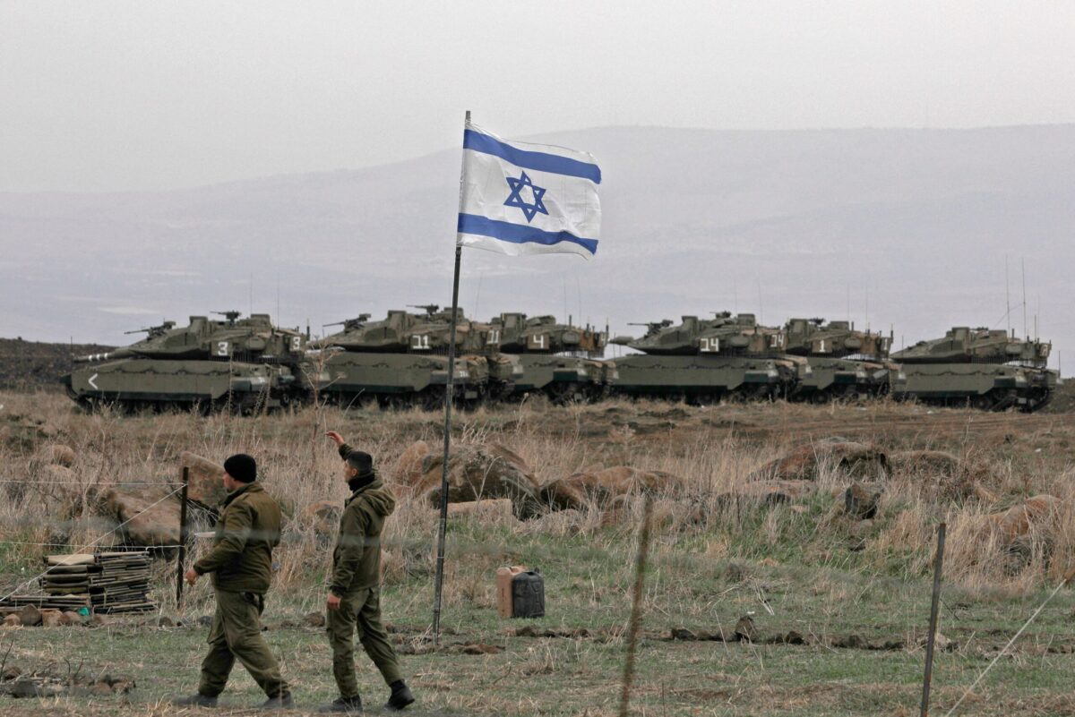 Israeli tanks are seen in action during a military drill in the Israel-annexed Golan Heights on December 7, 2021 [JALAA MAREY/AFP via Getty Images]