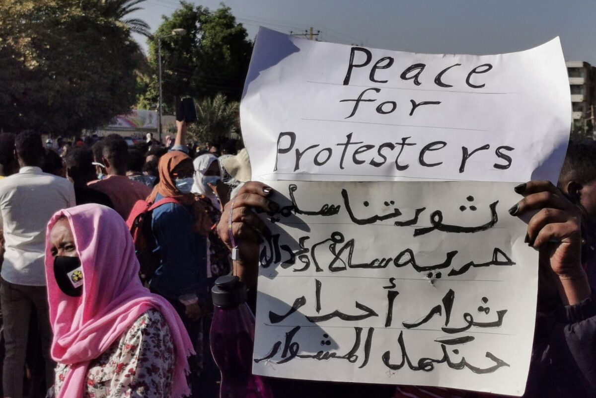 A woman raises a placard in the Sudanese capital Khartoum on January 20, 2022 [AFP via Getty Images]