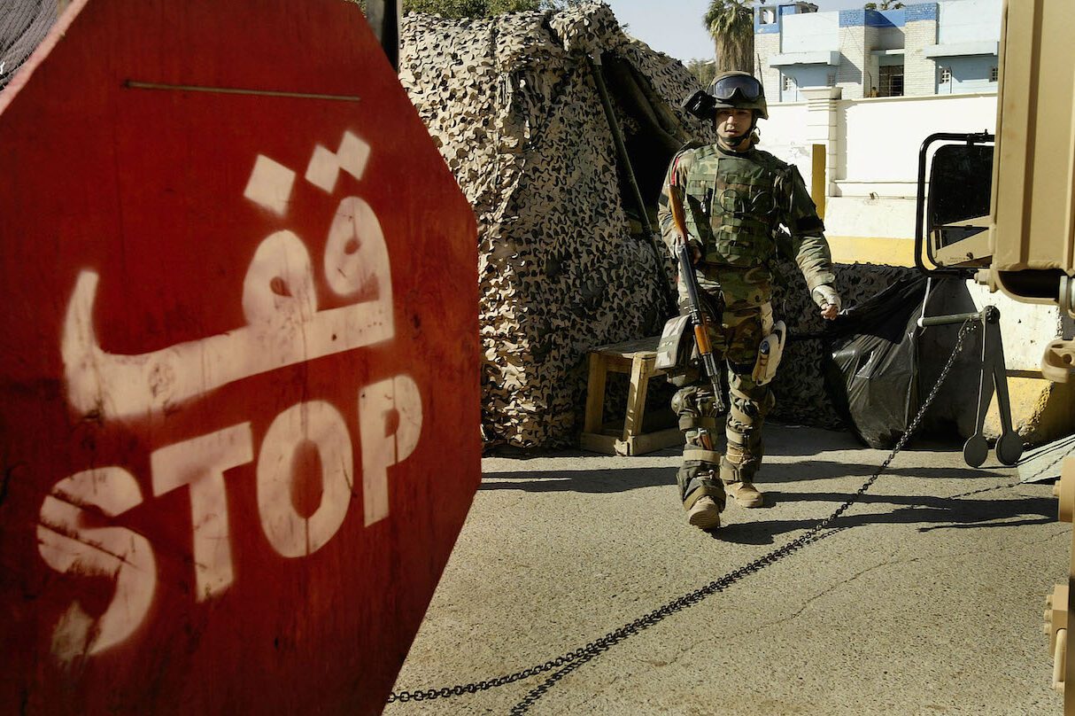An Iraqi army soldier stands guard at the Green Zone gate on January 1, 2009 at the Green Zone area in Baghdad, Iraq. [Wathiq Khuzaie/Getty Images]