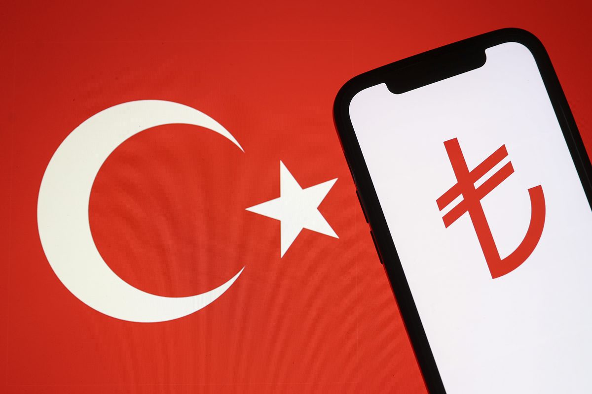 In this photo illustration flag of Turkiye is displayed on a laptop screen and the symbol of Turkish Lira is displayed on a mobile phone screen in Ankara, Turkiye on May 03, 2022. [Celal Güneş - Anadolu Agency]