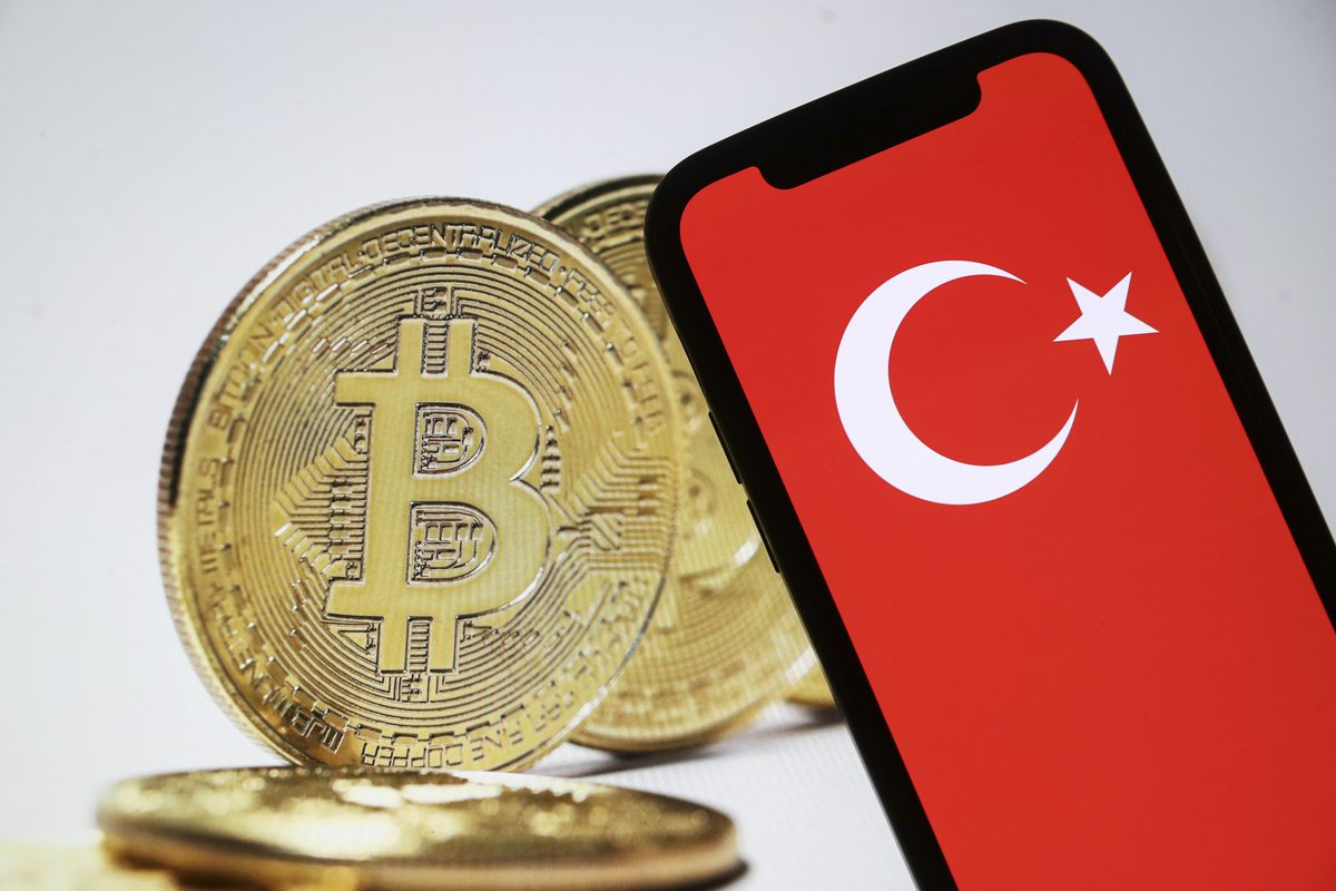 In this photo illustration flag of Turkiye is displayed on a mobile phone screen and the symbol of Bitcoin cryptocurrency is displayed on a laptop screen in Ankara, Turkiye on May 03, 2022 [Celal Güneş - Anadolu Agency]