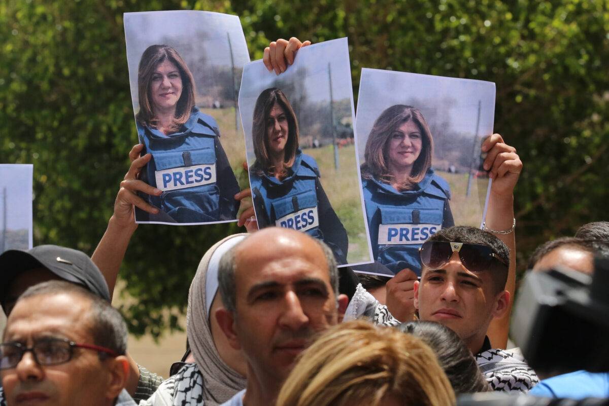Press members holding photos of female reporter of Al-Jazeera television channel Shireen Abu Akleh, in Nablus, West Bank on May 11, 2022 [Nedal Eshtayah/Anadolu Agency]