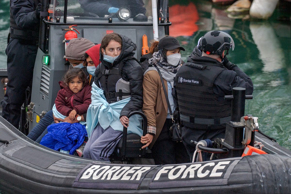 DOVER, UNITED KINGDOM - MAY 23: Migrants are brought ashore by a RNLI lifeboat in Dover, UK on May 23, 2022. A small group of migrants, including young children, arrived in the UK after crossing the Channel in calm weather conditions. The British Border Force officers carried the children off the boat as the migrants were escorted into the port to be processed. ( Stuart Brock - Anadolu Agency )