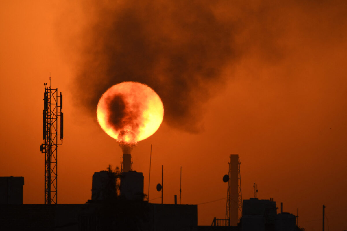 The sun sets over an oil refinery in the southern Iraqi town of Nasiriyah on March 8, 2021 [ASSAAD AL-NIYAZI/AFP via Getty Images]