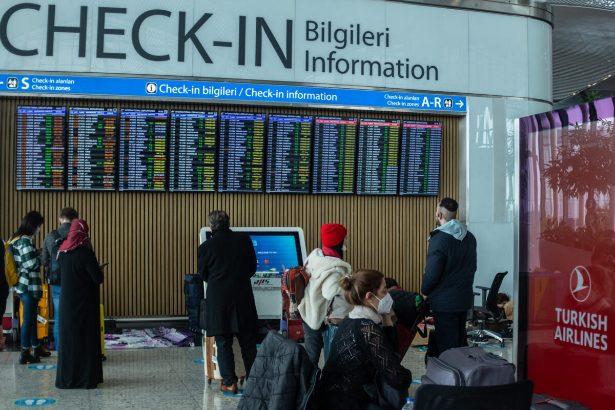 Passengers look at the departure information board in Istanbul Airport on January 25, 2022 [Burak Kara/Getty Images]