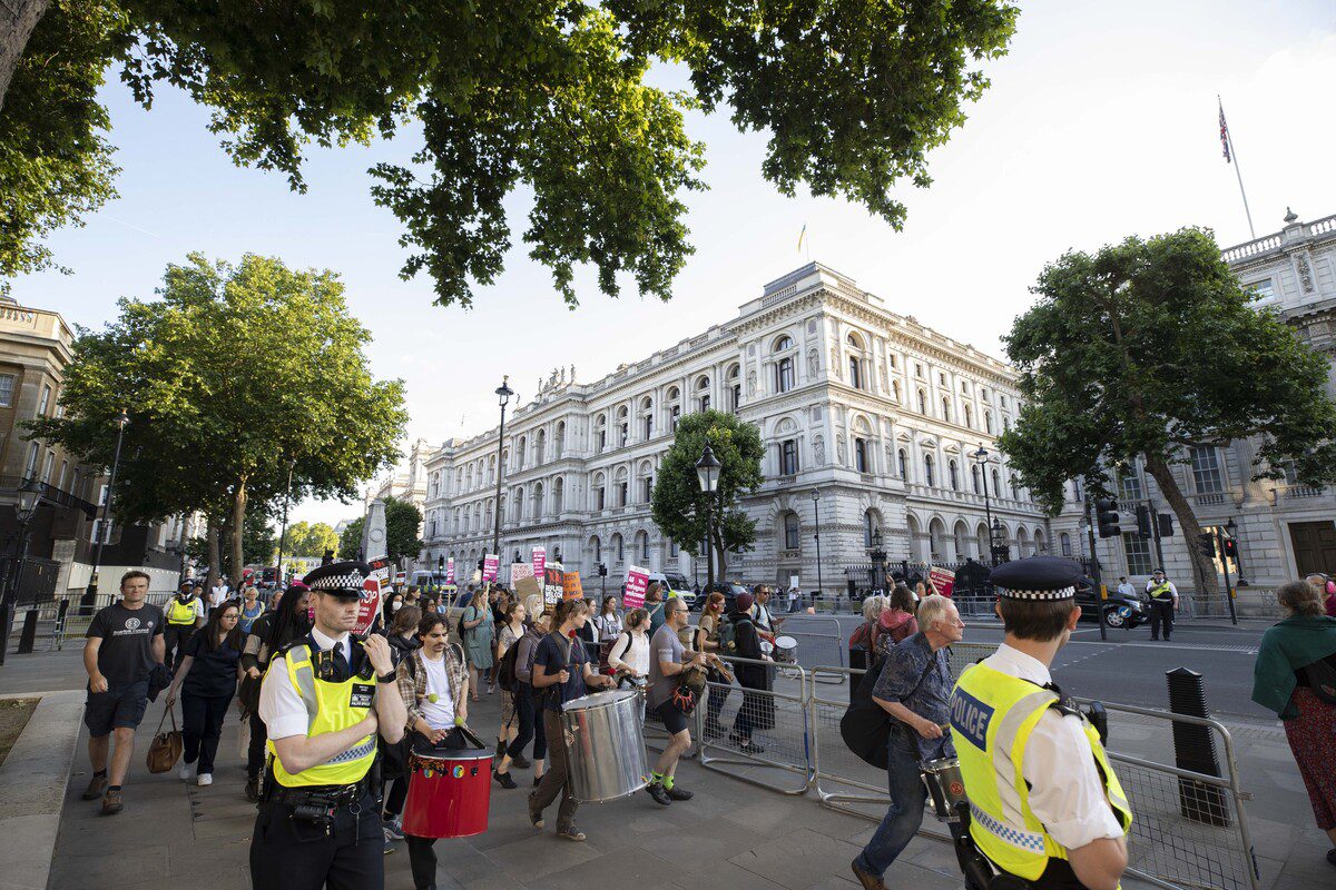 Hundreds of demonstrators gather during a protest against the UK's plan to send migrants and asylum seekers to Rwanda and the court's decision on the matter in front of the Ministry of Interior in London, United Kingdom on June 13, 2022. [Raşid Necati Aslım - Anadolu Agency ]