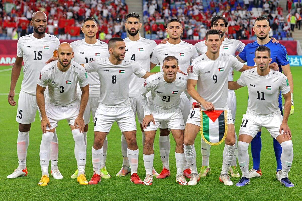 Palestine's squad pose for a group picture during the FIFA Arab Cup 2021 group C football match between Morocco and Palestine at the Al-Janoub Stadium in the Qatari city of Al-Wakrah on December 1, 2021. [KARIM SAHIB/AFP via Getty Images]