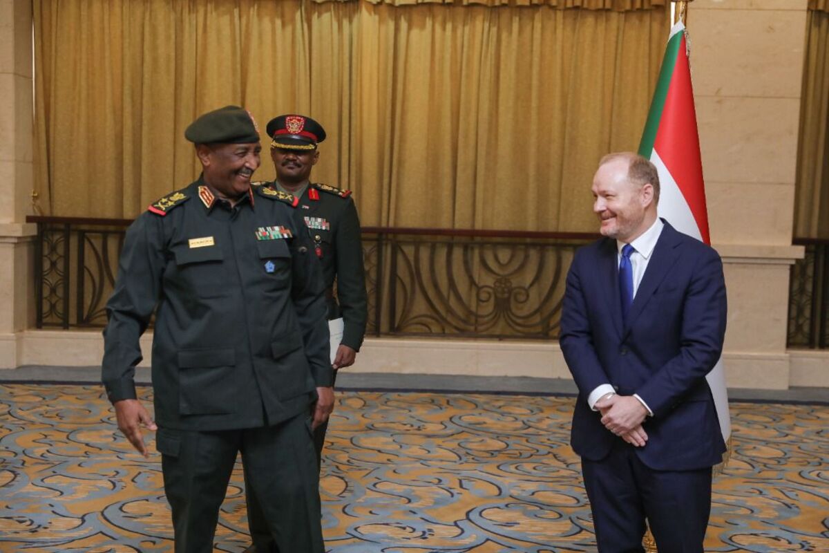 New US Ambassador in Sudan John Godfrey (R) smiles after presenting the letter of credence to Chairman of the Transitional Sovereignty Council, Abdel Fattah al-Burhan (L) at the presidential palace in Khartoum, Sudan on September 01, 2022 [Sudan Sovereignty Council Press - Anadolu Agency]