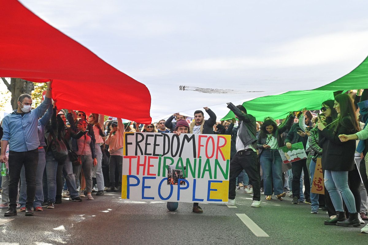 People take part in solidarity protest on September 25, 2022, in Paris, France, for Mahsa Amini, a 22 years old Iranian woman who died under custody after being detained by Iran's morality police for allegedly wearing her hijab head covering improperly. [Mustafa Yalçın - Anadolu Agency]