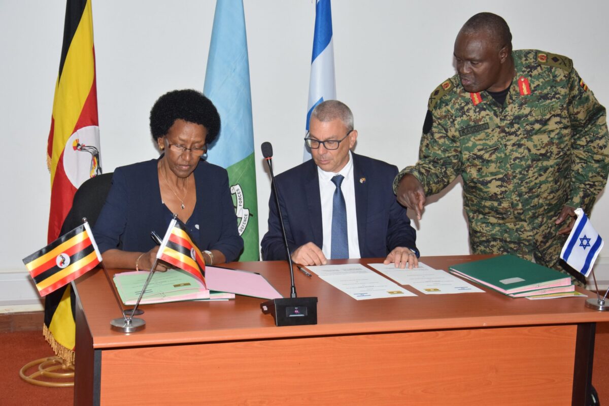 Ministry’s Permanent Secretary, Rosette Byengoma, signs on behalf of the Uganda Government while Asaf Dvir signs for the Israel Defence Forces [@RashadLubega/Twitter]
