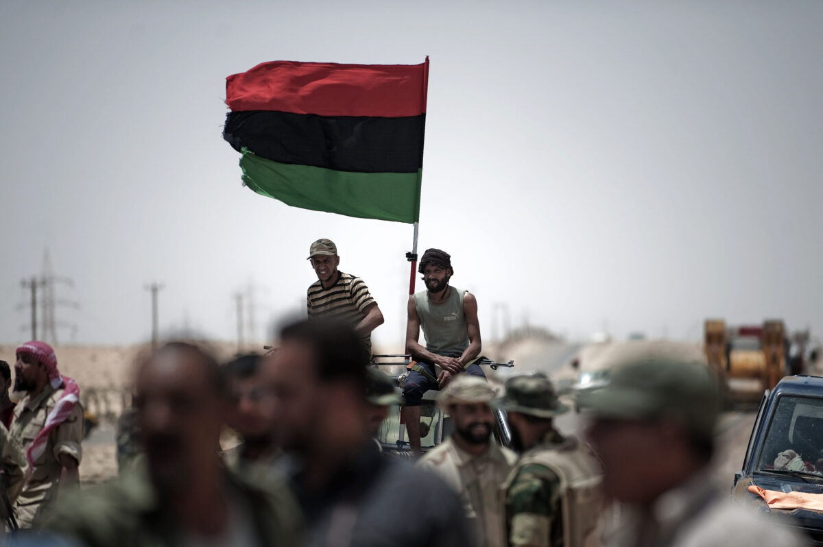 Libyan rebels sit on top of a pick-up truck west of Ajdabiya on July 19, 2011 [ GIANLUIGI GUERCIA/AFP via Getty Images]