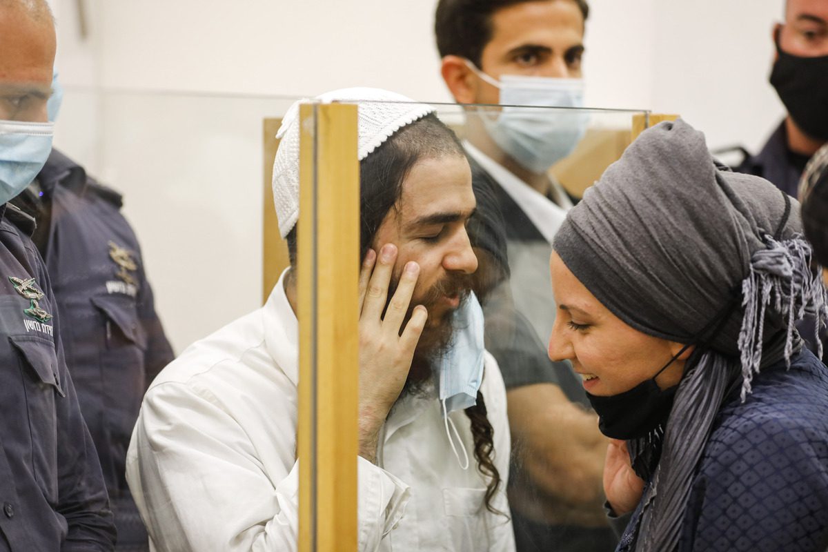 Israeli settler Amiram Ben-Uliel [left] was convicted of two counts each of attempted murder and arson, along with conspiracy to commit a hate crime in the 2015 attack that killed the Palestinian Dawabsheh family. [Photo by Menahem Kahana/AFP via Getty Images]