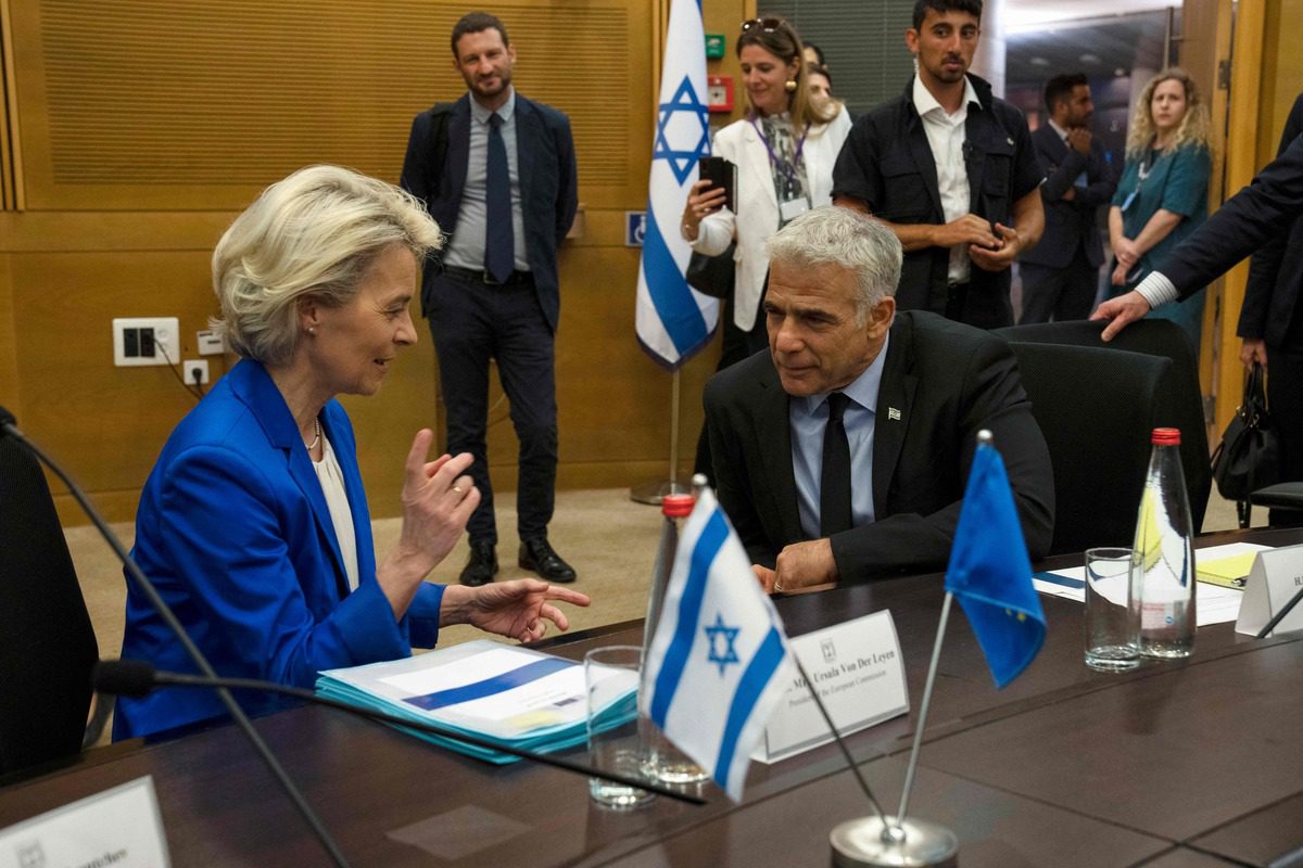 European Commission President Ursula von der Leyen (L) chats with Israeli Foreign Minister Yair Lapid before their meeting at the Knesset (Parliament) in Jerusalem, on June 13, 2022. [Photo by MAYA ALLERUZZO/POOL/AFP via Getty Images]