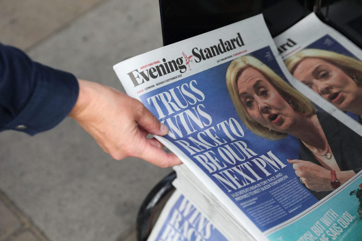 A person takes a copy of the British newspaper Evening Standard picturing Britain's New Conservative Party leader and incoming prime minister Liz Truss following her election, London on September 5, 2022 [ISABEL INFANTES/AFP via Getty Images]
