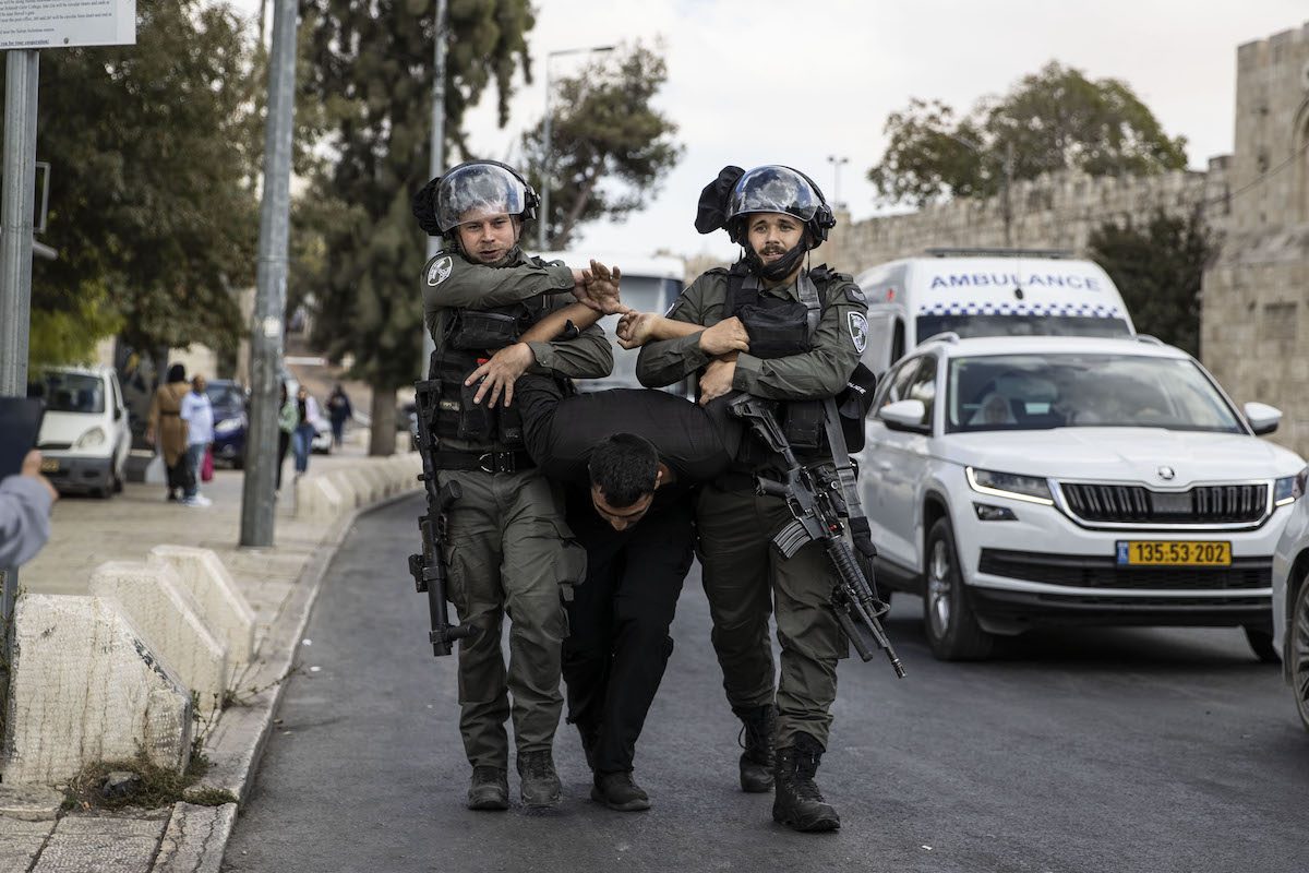 Israeli forces detain Palestinian Muslims marching as part of the event held for Mawlid al-Nabi at the Damascus Gate of the Old City in Jerusalem on October 08, 2022. [Mostafa Alkharouf - Anadolu Agency]