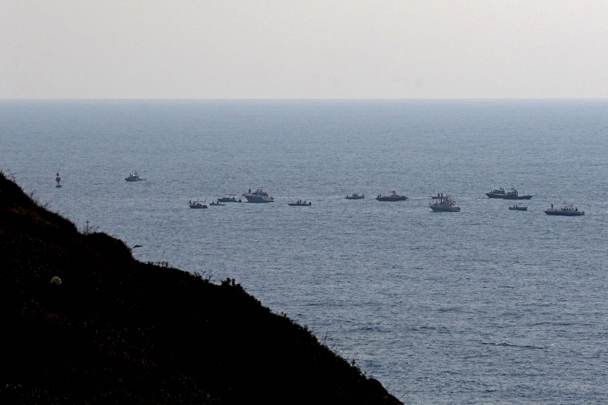 Lebanese protesters sail in boats with slogans affirming Lebanon's right to its offshore gas wealth, near a border-marking buoy between Israel and Lebanon in the Mediterranean waters off the southern town of Naqoura on September 4, 2022. [MAHMOUD ZAYYAT/AFP via Getty Images]