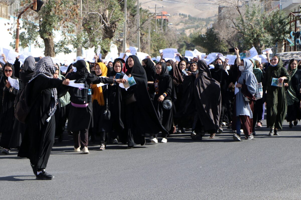 Afghan female students chant "Education is our right, genocide is a crime" during a protest as they march from the University of Herat toward to the provincial governor office in Herat on October 2,2022, two days after a suicide bomb attack in a learning centre in Kabul. (Photo by Mohsen KARIMI / AFP) (Photo by MOHSEN KARIMI/AFP via Getty Images)