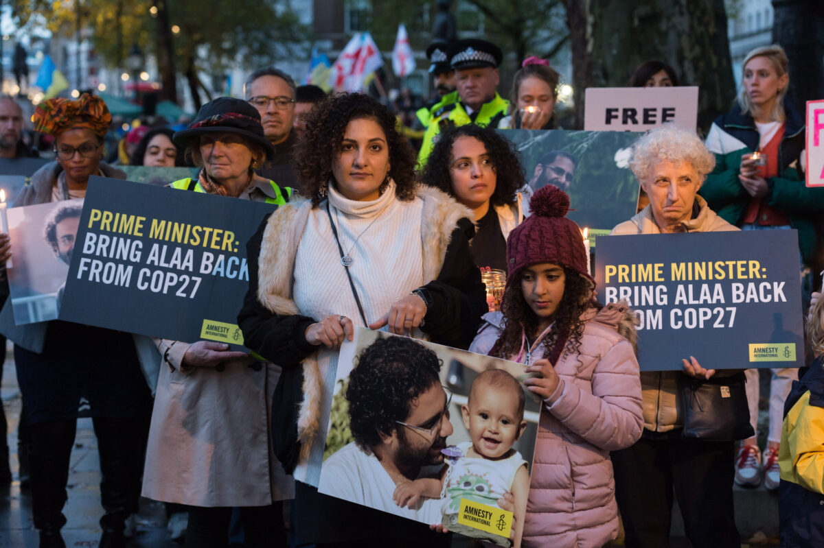 Mona Seif (CL), sister of the jailed British-Egyptian human rights activist Alaa Abd el-Fattah, is joined by supporters during a candlelight vigil outside Downing Street to demonstrate concern for her brother who is beginning a complete hunger strike as world leaders arrive for COP27 climate summit in Sharm el-Sheikh in London, United Kingdom on November 06, 2022 [Wiktor Szymanowicz/Anadolu Agency]