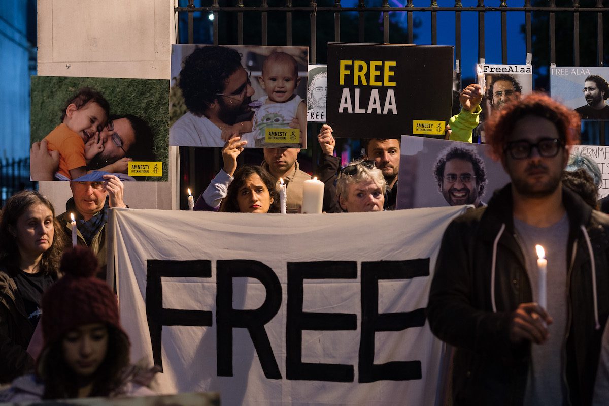 Supporters of the jailed British-Egyptian human rights activist Alaa Abd el-Fattah take part in a candlelight vigil outside Downing Street as he begins a complete hunger strike while world leaders arrive for COP27 climate summit in Sharm el-Sheikh in London, United Kingdom on November 06, 2022. [Wiktor Szymanowicz - Anadolu Agency]