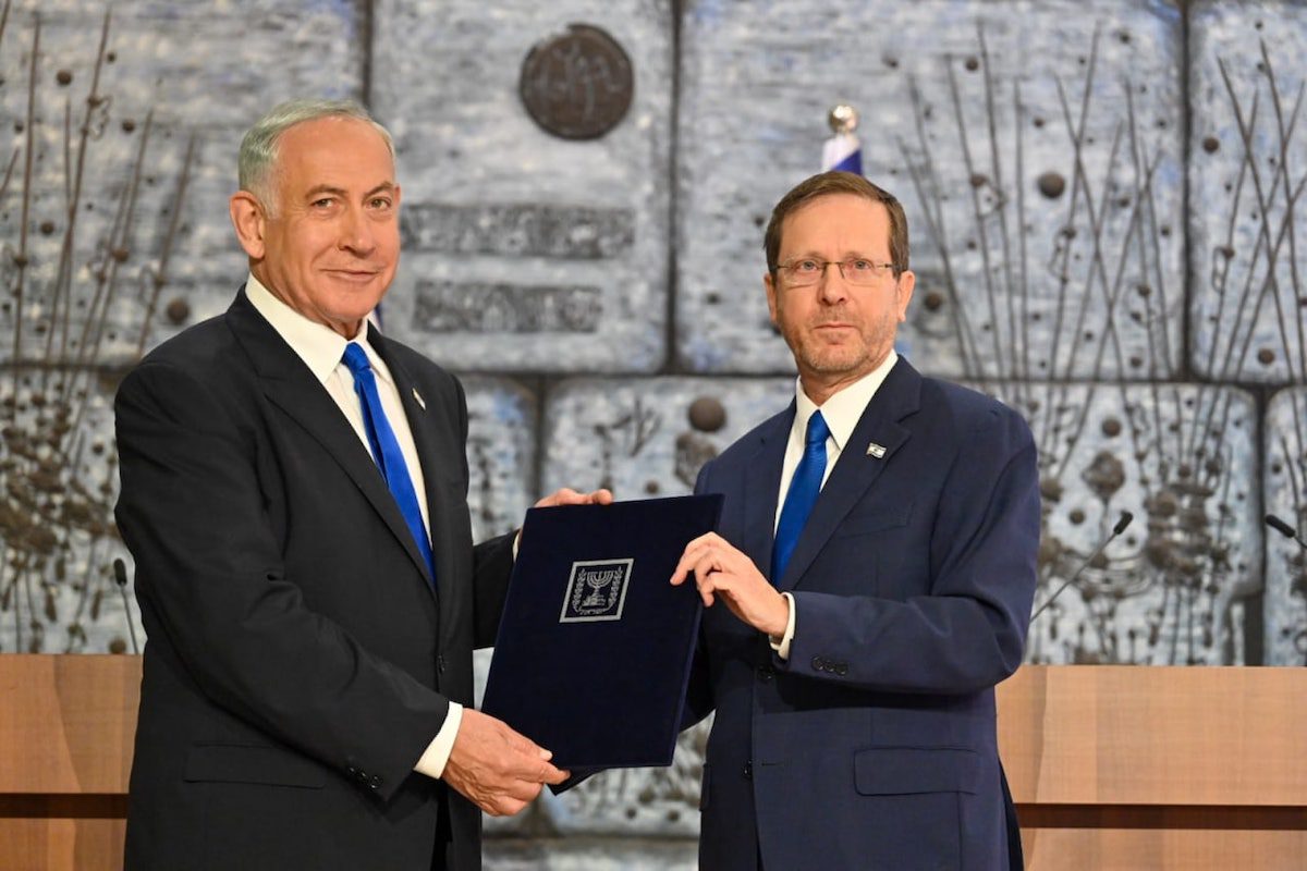 Likud Party leader Benjamin Netanyahu (L) receives the mandate to form the government after meeting with President Isaac Herzog (R) in Jerusalem on November 13, 2022. [GPO - Anadolu Agency]