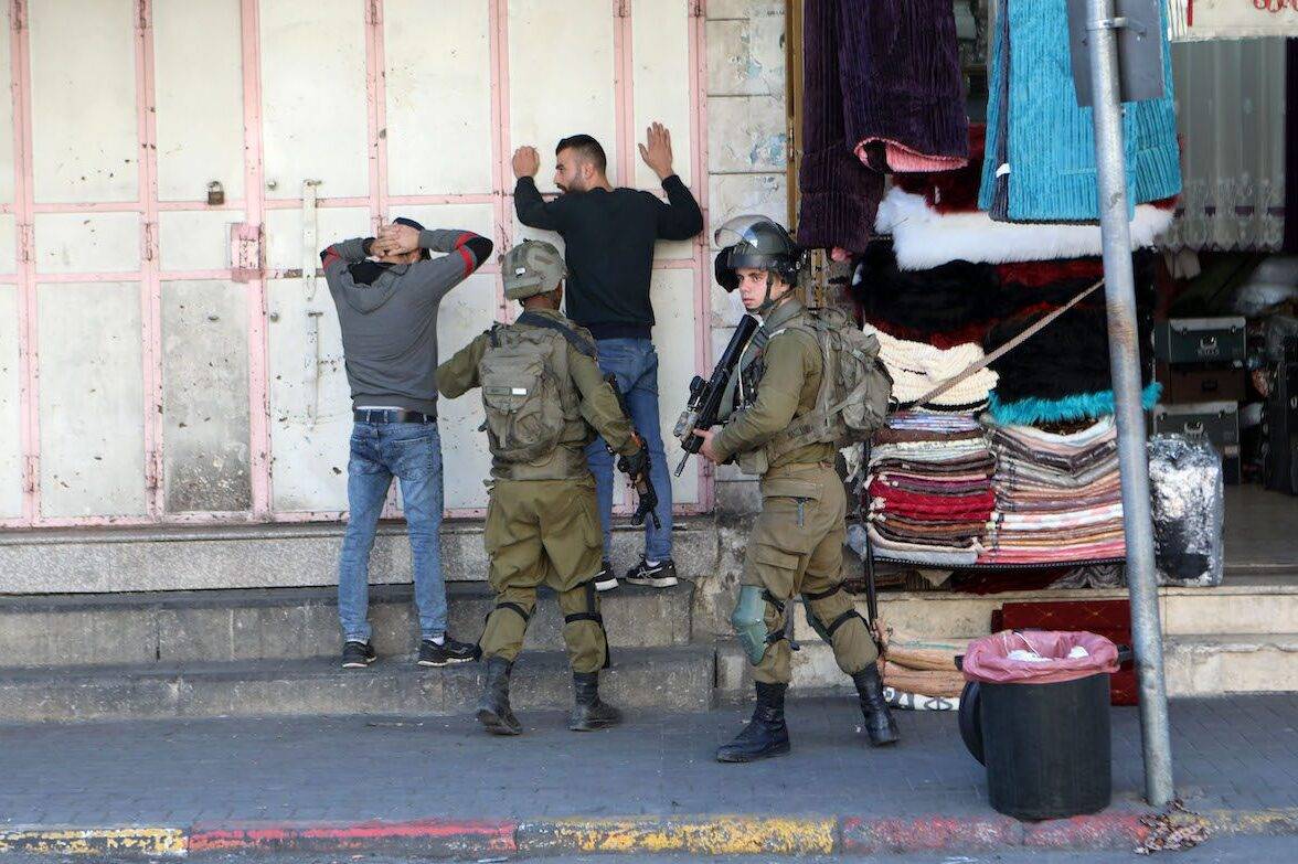 Israeli forces arrest Palestinians in Hebron, West Bank on November 19, 2022 [Mamoun Wazwaz/Anadolu Agency]