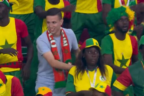 Morocco fan dances with Senegal supporters